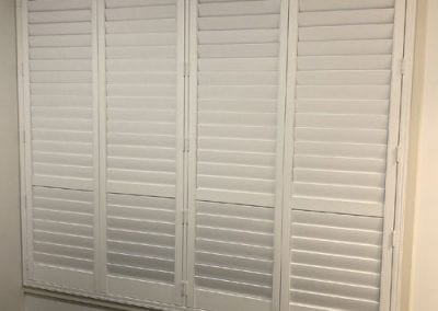 white plantation shutters on windows