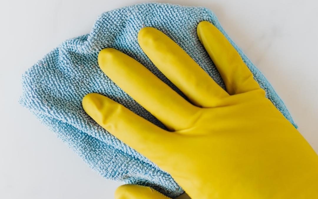 Hand using a microfiber cloth to clean roller shutters