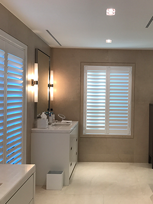 white plantation shutters in the bathroom