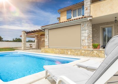 Ezip outdoor blinds next to a pool