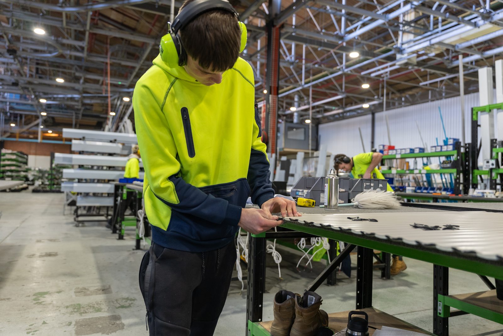 DHE team member working at a bench in the Elizabeth South factory